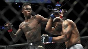 UFC middleweight champion Israel Adesanya of Nigeria and Yoel Romero of Cuba mix it up during UFC 248 at T-Mobile Arena in Las Vegas.(AP) UFC middleweight champion Israel Adesanya of Nigeria and Yoel Romero of Cuba mix it up during UFC 248 at T-Mobile Arena in Las Vegas.(AP)