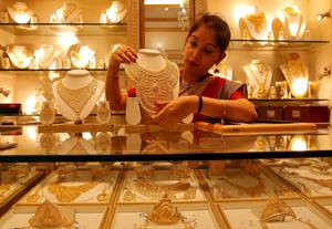 A saleswoman displays a gold necklace inside a jewellery showroom on the occasion of Akshaya Tritiya, a major gold buying festival, in Kolkata, in this file photo.(Reuters Photo) A saleswoman displays a gold necklace inside a jewellery showroom on the occasion of Akshaya Tritiya, a major gold buying festival, in Kolkata, in this file photo.(Reuters Photo)