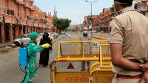 A health worker sanitizes barricades at Ramganj in Jaipur.(Himanshu Vyas/HT PHOTO) A health worker sanitizes barricades at Ramganj in Jaipur.(Himanshu Vyas/HT PHOTO)