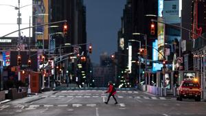 A woman walks through an almost-deserted Times Square in the early morning hours on April 23, 2020 in New York City.(AFP) A woman walks through an almost-deserted Times Square in the early morning hours on April 23, 2020 in New York City.(AFP)