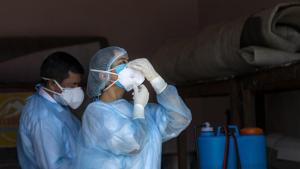 A doctor wears her protective mask before collecting samples from people to be tested for the coronavirus in Dharmsala, India.(AP) A doctor wears her protective mask before collecting samples from people to be tested for the coronavirus in Dharmsala, India.(AP)