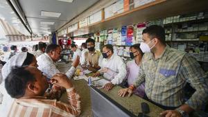 Salesmen at a chemist shop wear protective masks in wake of the deadly novel coronavirus.(PTI) Salesmen at a chemist shop wear protective masks in wake of the deadly novel coronavirus.(PTI)