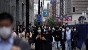 People wearing face masks walk at a main shopping area, following an outbreak of the novel coronavirus disease, in Shanghai, China.(REUTERS) People wearing face masks walk at a main shopping area, following an outbreak of the novel coronavirus disease, in Shanghai, China.(REUTERS)