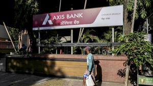 A pedestrian wearing a protective mask walks past an Axis Bank Ltd. branch on a near-empty street in Mumbai, India.(Bloomberg) A pedestrian wearing a protective mask walks past an Axis Bank Ltd. branch on a near-empty street in Mumbai, India.(Bloomberg)