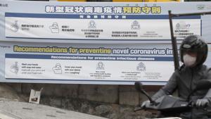 A man wearing a face mask rides a motorcycle past banners showing precautions against the new coronavirus near a temporary closed nightclubs and bars in Seoul, South Korea.(AP) A man wearing a face mask rides a motorcycle past banners showing precautions against the new coronavirus near a temporary closed nightclubs and bars in Seoul, South Korea.(AP)