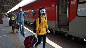 People with their luggage walk to board a train that will take them to New Delhi after India announced a limited reopening of its giant rail network following a nearly seven-week lockdown to slow the spreading of the coronavirus disease.(REUTERS) People with their luggage walk to board a train that will take them to New Delhi after India announced a limited reopening of its giant rail network following a nearly seven-week lockdown to slow the spreading of the coronavirus disease.(REUTERS)