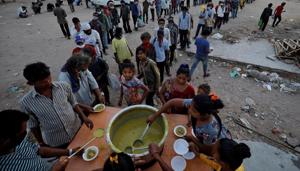 Migrant workers and homeless people stand in queue to receive free food during a nationwide lockdown to curb the spread of the coronavirus disease in India.(REUTERS PHOTO.) Migrant workers and homeless people stand in queue to receive free food during a nationwide lockdown to curb the spread of the coronavirus disease in India.(REUTERS PHOTO.)
