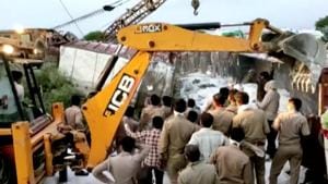 A police rescue team work to lift a truck at the site of an accident where a truck carrying migrant labourers collided with another, killing 24 and injuring several people in Auraiya, Uttar Pradesh.(ANI via Reuters)