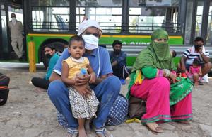 Migrant families wait for registration for special trains to their native places, at the inter-state bus terminal in Sector 43, Chandigarh.(Ravi Kumar/HT) Migrant families wait for registration for special trains to their native places, at the inter-state bus terminal in Sector 43, Chandigarh.(Ravi Kumar/HT)