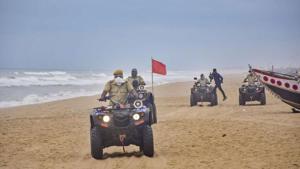 Marine police personnel patrol Puri beach to prevent tourists and fishermen from venturing into the sea due to Cyclone Amphan.(PTI Photo) Marine police personnel patrol Puri beach to prevent tourists and fishermen from venturing into the sea due to Cyclone Amphan.(PTI Photo)