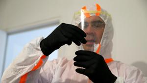 A French doctor, wearing a protective suit and a face mask, holds a test tube after administering a nasal swab to a 6-year-old child during a COVID-19 testing in Gouzeaucourt, during the outbreak of the coronavirus disease (COVID-19) in France, May 16, 2020. REUTERS/Pascal Rossignol(REUTERS) A French doctor, wearing a protective suit and a face mask, holds a test tube after administering a nasal swab to a 6-year-old child during a COVID-19 testing in Gouzeaucourt, during the outbreak of the coronavirus disease (COVID-19) in France, May 16, 2020. REUTERS/Pascal Rossignol(REUTERS)