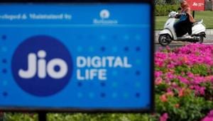 A woman rides her scooter past advertisements of Reliance Industries' Jio telecoms unit, in Ahmedabad, India, July 5, 2018.(REUTERS FILE) A woman rides her scooter past advertisements of Reliance Industries' Jio telecoms unit, in Ahmedabad, India, July 5, 2018.(REUTERS FILE)