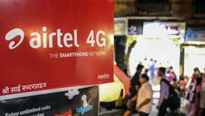 People walk past an advertisement for Bharti Airtel Ltd. in Mumbai.(Bloomberg File) People walk past an advertisement for Bharti Airtel Ltd. in Mumbai.(Bloomberg File)