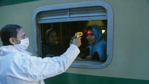 A Pakistani volunteer checks the body temperature of a passenger to help detect coronavirus, at a railway station in Lahore, Pakistan, Wednesday, March 18, 2020.(AP) A Pakistani volunteer checks the body temperature of a passenger to help detect coronavirus, at a railway station in Lahore, Pakistan, Wednesday, March 18, 2020.(AP)