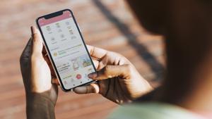 A housing society resident using the MyGate app. A housing society resident using the MyGate app.
