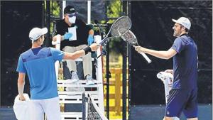 Poland’s Hubert Hurkacz (left) and Reilly Opelka of the US tap racquets after their match during the Pro Match Series in Florida. Players are banned from shaking hands under new safety guidelines Poland’s Hubert Hurkacz (left) and Reilly Opelka of the US tap racquets after their match during the Pro Match Series in Florida. Players are banned from shaking hands under new safety guidelines