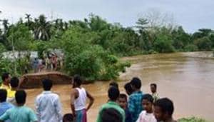Nagaon: Villagers watch a washed away road after flooding by Borpani River due to incessant rainfall for the past two days, at Madhab Para near Kampur in Nagaon district of Assam(PTI)