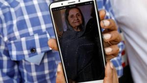 Shahid Ahmed holds his mobile phone displaying photo of his mother Irshad Begum, 72, who was killed in a plane crash, outside a morgue in Karachi, Pakistan.(Reuters) Shahid Ahmed holds his mobile phone displaying photo of his mother Irshad Begum, 72, who was killed in a plane crash, outside a morgue in Karachi, Pakistan.(Reuters)