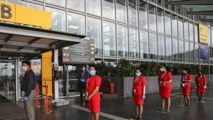AirAsia staff members stand on social distancing markings, as they wait to enter Netaji Subhas Chandra Bose International Airport in Kolkata, on Wednesday.(Reuters Photo) AirAsia staff members stand on social distancing markings, as they wait to enter Netaji Subhas Chandra Bose International Airport in Kolkata, on Wednesday.(Reuters Photo)