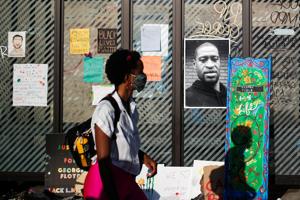 A picture of African-American man George Floyd is seen at a makeshift memorial put up by protesters at the corner where he got arrested, in the aftermath of a white police officer getting caught on a bystander's video pressing his knee into Floyd's neck, who later died at a hospital, in Minneapolis, Minnesota, US.(REUTERS) A picture of African-American man George Floyd is seen at a makeshift memorial put up by protesters at the corner where he got arrested, in the aftermath of a white police officer getting caught on a bystander's video pressing his knee into Floyd's neck, who later died at a hospital, in Minneapolis, Minnesota, US.(REUTERS)