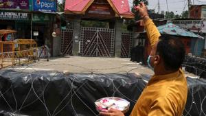 A man prays and makes an offering at the entrance to the Kheer Bhawani temple at Tulmulla in Ganderbal with no congregation held on the occasion of Mela Kheer Bhawani due to lockdown restrictions in Ganderbal, Jammu and Kashmir.(HT Photo) A man prays and makes an offering at the entrance to the Kheer Bhawani temple at Tulmulla in Ganderbal with no congregation held on the occasion of Mela Kheer Bhawani due to lockdown restrictions in Ganderbal, Jammu and Kashmir.(HT Photo)