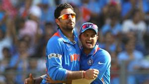 Yuvraj Singh (L) of India is congratulated by team mate Suresh Raina(Getty Images)