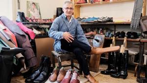 Romanian shoemaker Grigore Lup poses for a portrait while showcasing a pair of his long-nosed leather shoes to help keeping social distance.(REUTERS) Romanian shoemaker Grigore Lup poses for a portrait while showcasing a pair of his long-nosed leather shoes to help keeping social distance.(REUTERS)