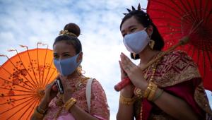 Women wearing protective face masks and dressed in traditional costumes visit Wat Chaiwatthanaram after the Thai government eased isolation measures to prevent the spread of the coronavirus disease (COVID-19) in the city of Ayutthaya Historical Park, Thailand, June 1, 2020. REUTERS/Athit Perawongmetha(REUTERS)