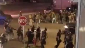 The SUV drove around an armored vehicle and sped off as more gunfire sounded.(@Tytaninc/Twitter) The SUV drove around an armored vehicle and sped off as more gunfire sounded.(@Tytaninc/Twitter)