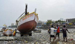 An earthmover carries a boat as fishermen take precautionary measures ahead of Cyclone Nisarga, in Mumbai, June 2(PTI)