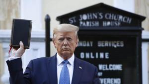 President Donald Trump holds a Bible as he visits St. John's Church. Part of the church was set on fire during protests on Sunday night.(AP) President Donald Trump holds a Bible as he visits St. John's Church. Part of the church was set on fire during protests on Sunday night.(AP)