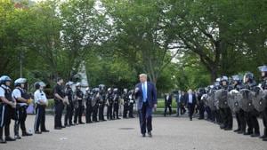 US President Donald Trump pumps his fist toward police as he walks between lines of riot police in Lafayette Park across from the White House while walking to St John's Church for a photo opportunity during ongoing protests over racial inequality in the wake of the death of George Floyd while in Minneapolis police custody, at the White House in Washington, US.(REUTERS) US President Donald Trump pumps his fist toward police as he walks between lines of riot police in Lafayette Park across from the White House while walking to St John's Church for a photo opportunity during ongoing protests over racial inequality in the wake of the death of George Floyd while in Minneapolis police custody, at the White House in Washington, US.(REUTERS)