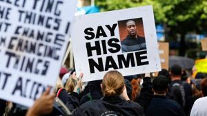A protester holds a placard during a rally against the death in Minneapolis police custody of George Floyd, in Portland, Oregon, US.(REUTERS) A protester holds a placard during a rally against the death in Minneapolis police custody of George Floyd, in Portland, Oregon, US.(REUTERS)