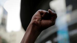 A closed fist is pictured during a rally against the death in Minneapolis police custody of George Floyd, in Times Square in the Manhattan borough of New York City, US.(REUTERS) A closed fist is pictured during a rally against the death in Minneapolis police custody of George Floyd, in Times Square in the Manhattan borough of New York City, US.(REUTERS)