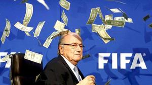 British comedian Lee Nelson (unseen) throws fake money bills at FIFA president Sepp Blatter at a news conference in Zurich on July 20, 2015.(Reuters Photo) British comedian Lee Nelson (unseen) throws fake money bills at FIFA president Sepp Blatter at a news conference in Zurich on July 20, 2015.(Reuters Photo)