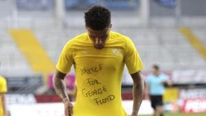 Jadon Sancho of Borussia Dortmund celebrates scoring his teams second goal of the game with a 'Justice for George Floyd' shirt.(AP)