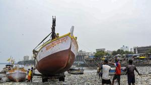 Mumbai: An earthmover carries a boat as fishermen prepare at Badhwar Park in Colaba ahead of the Cyclone Nisarga, in Mumbai(PTI) Mumbai: An earthmover carries a boat as fishermen prepare at Badhwar Park in Colaba ahead of the Cyclone Nisarga, in Mumbai(PTI)