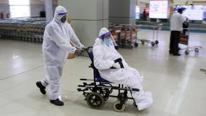 Passengers wearing personal protective equipment (PPE) arrive at Tripura airport from Kolkata on Tuesday.(ANI Photo) Passengers wearing personal protective equipment (PPE) arrive at Tripura airport from Kolkata on Tuesday.(ANI Photo)