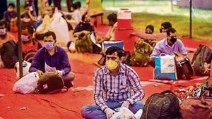 Migrants waiting to get screened before transit buses ferry them to railway stations to board Shramik Special trains. Migrants waiting to get screened before transit buses ferry them to railway stations to board Shramik Special trains.
