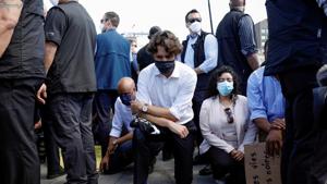 Canada's Prime Minister Justin Trudeau wears a mask as he takes a knee during a rally against the death in Minneapolis police custody of George Floyd, on Parliament Hill, in Ottawa, Ontario, Canada.(REUTERS) Canada's Prime Minister Justin Trudeau wears a mask as he takes a knee during a rally against the death in Minneapolis police custody of George Floyd, on Parliament Hill, in Ottawa, Ontario, Canada.(REUTERS)