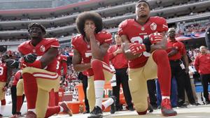 San Francisco 49ers outside linebacker Eli Harold, quarterback Colin Kaepernick (C) and safety Eric Reid kneel during the national anthem before an NFL football game against the Dallas Cowboys in Santa Clara.(AP) San Francisco 49ers outside linebacker Eli Harold, quarterback Colin Kaepernick (C) and safety Eric Reid kneel during the national anthem before an NFL football game against the Dallas Cowboys in Santa Clara.(AP)