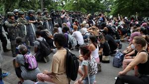 Demonstrators take a knee in front of law enforcement officers during a protest against the death in Minneapolis police custody of George Floyd, near the White House in Washington, US.(REUTERS) Demonstrators take a knee in front of law enforcement officers during a protest against the death in Minneapolis police custody of George Floyd, near the White House in Washington, US.(REUTERS)