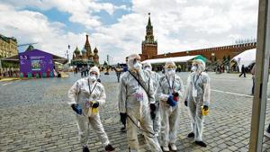 Volunteers in protective gear gather to clean an area of an outdoor book market set up at Red Square in Moscow on Saturday. Volunteers in protective gear gather to clean an area of an outdoor book market set up at Red Square in Moscow on Saturday.