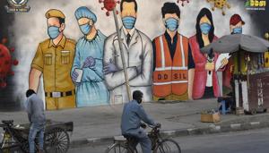 A cyclist rides past a mural - paying tribute to forntline coronavirus workers amid the lockdown, near Garhi Chowk, in New Delhi(Sanjeev Verma/HT PHOTO) A cyclist rides past a mural - paying tribute to forntline coronavirus workers amid the lockdown, near Garhi Chowk, in New Delhi(Sanjeev Verma/HT PHOTO)