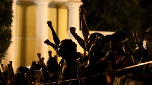 Demonstrators raise their fists in the air near the White House, during a protest against racial inequality in the aftermath of the death in Minneapolis police custody of George Floyd, in Washington, US.(REUTERS) Demonstrators raise their fists in the air near the White House, during a protest against racial inequality in the aftermath of the death in Minneapolis police custody of George Floyd, in Washington, US.(REUTERS)
