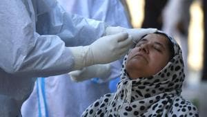 A health worker collects a nasopharyngeal swab sample at a coronavirus testing centre Srinagar.(Waseem Andrabi/HT PHOTO) A health worker collects a nasopharyngeal swab sample at a coronavirus testing centre Srinagar.(Waseem Andrabi/HT PHOTO)