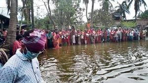 In Harinhula village, local residents line up for relief material as water levels rise due to the full-moon tide . In Harinhula village, local residents line up for relief material as water levels rise due to the full-moon tide .