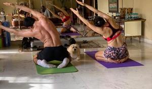 Sara Ali Khan and Ibrahim Ali Khan doing yoga as their dog Fuffy watches. Sara Ali Khan and Ibrahim Ali Khan doing yoga as their dog Fuffy watches.