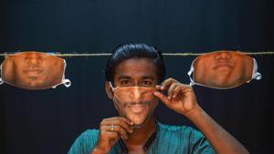 Chennai: A man adjusts a face-mask with his face image printed on it, created at a photo studio, during ongoing COVID-19 lockdown in Chennai, Sunday, June 7, 2020. (PTI Photo) (PTI07-06-2020_000157A)(PTI) Chennai: A man adjusts a face-mask with his face image printed on it, created at a photo studio, during ongoing COVID-19 lockdown in Chennai, Sunday, June 7, 2020. (PTI Photo) (PTI07-06-2020_000157A)(PTI)