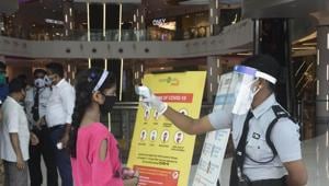 A security guard thermal screening people at South City Mall in Kolkata after it opened to the public on Monday, June 8, 2020.(Samir Jana / HT Photo) A security guard thermal screening people at South City Mall in Kolkata after it opened to the public on Monday, June 8, 2020.(Samir Jana / HT Photo)